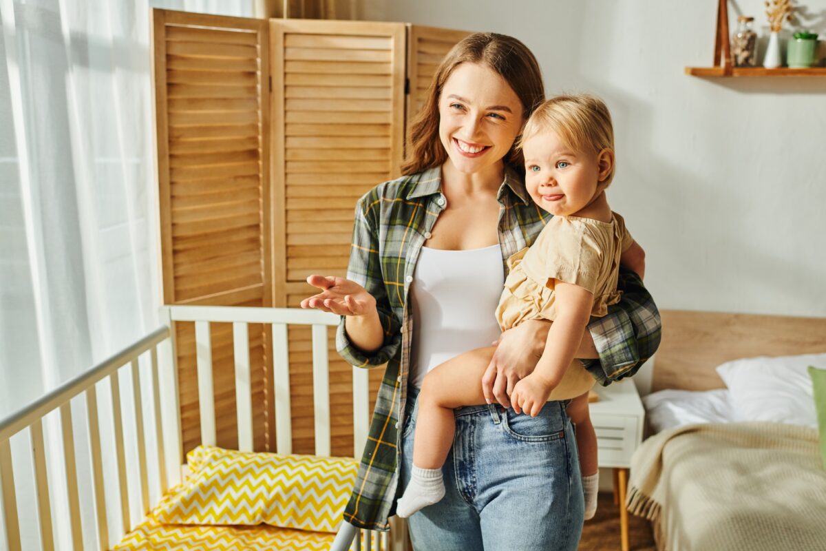 A young mother lovingly cradles her toddler daughter in her arms